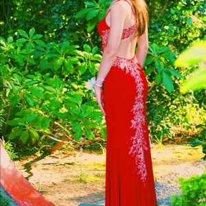 Red prom dress with gold lace trim around the sides going down the back